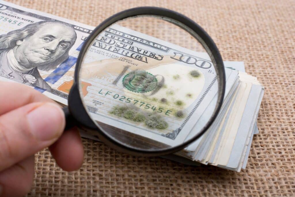 A stack of money thats has small amounts of mold growth