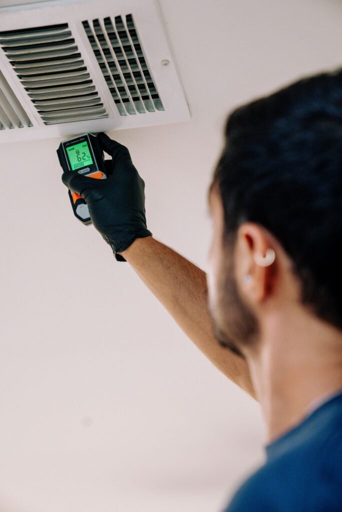 Moisture meter reading 62 percent at a ceiling supply vent during a Houston mold and moisture assessment