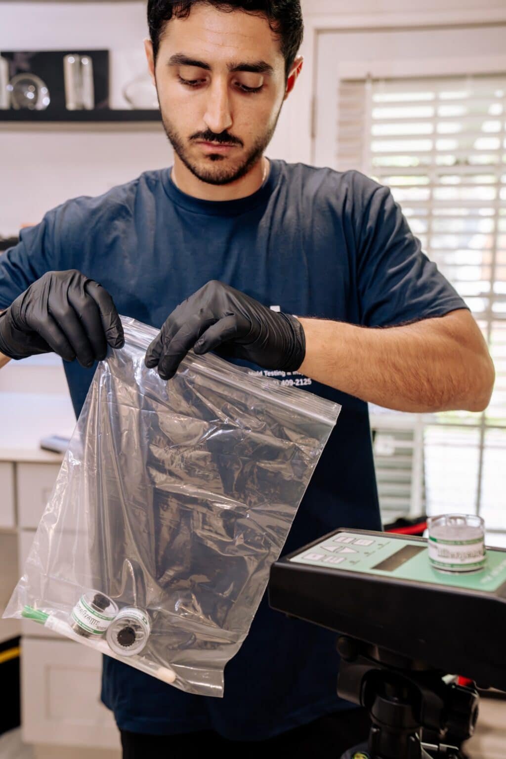 Mold assessor sealing collected spore trap cassettes into a chain of custody sample bag for lab shipment
