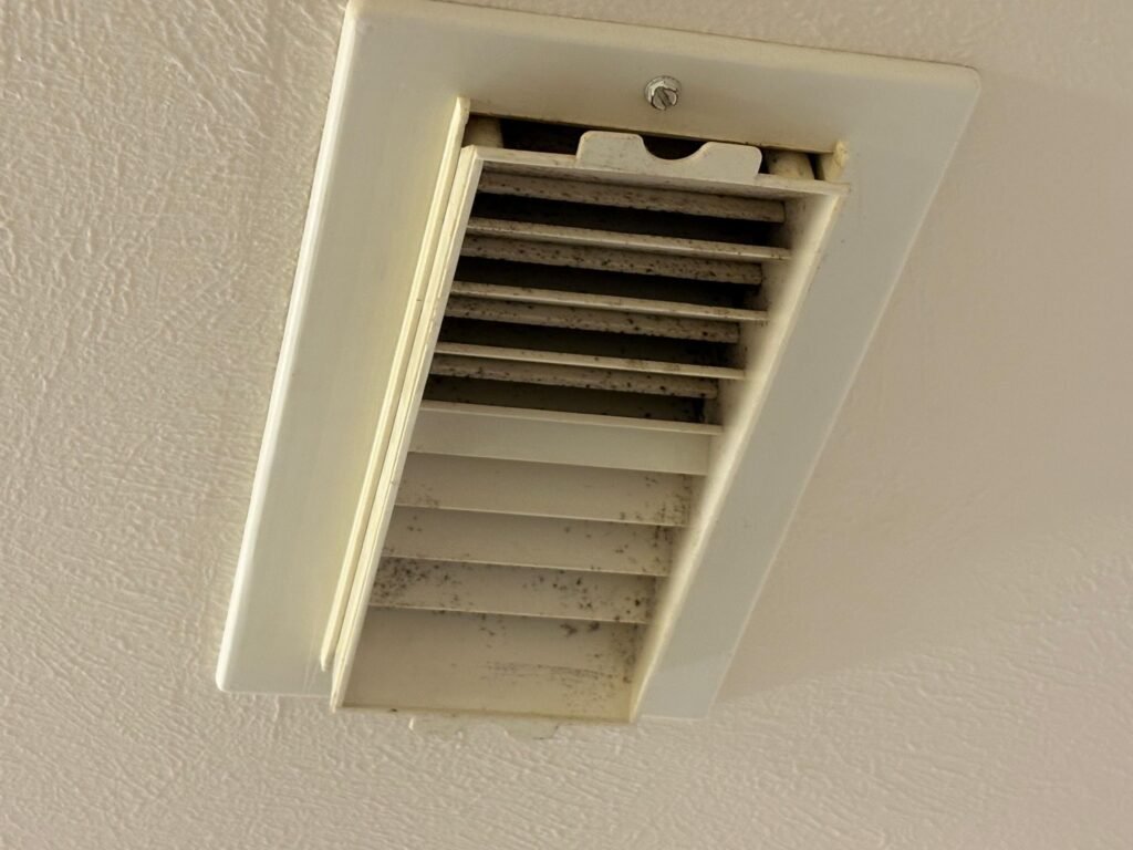Ceiling supply register showing discoloration in a Sugar Land home