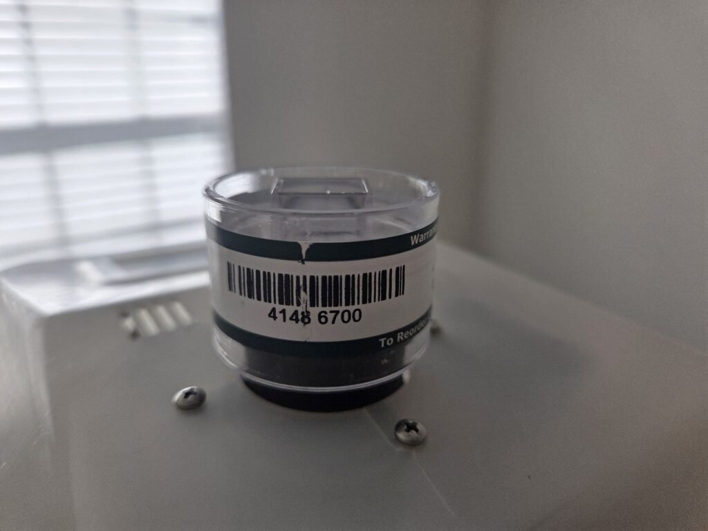 Spore trap cassette collecting an air sample during a Katy mold inspection