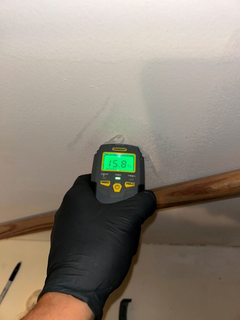 Moisture reading taken at a baseboard in a West University home