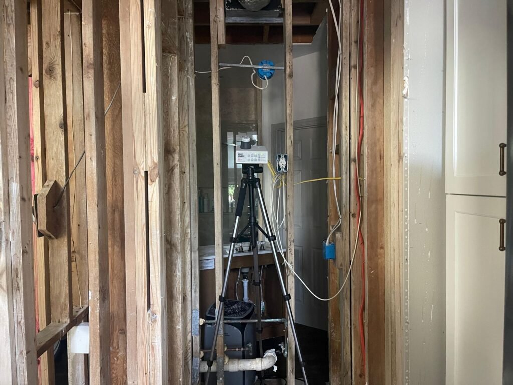 Wall cavity opened for inspection after a leak affected multiple rooms