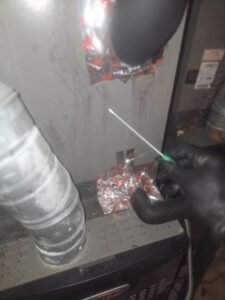 Mold assessor taking a surface swab sample from an air handler cabinet in Pearland