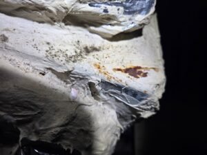 Dark spotting and rust on duct mastic at an attic duct boot in a Pearland home