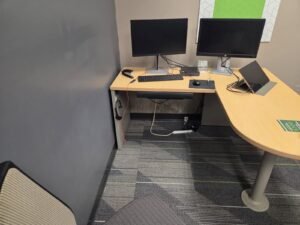 Mold growth on the lower wall beneath a desk in a Pearland office